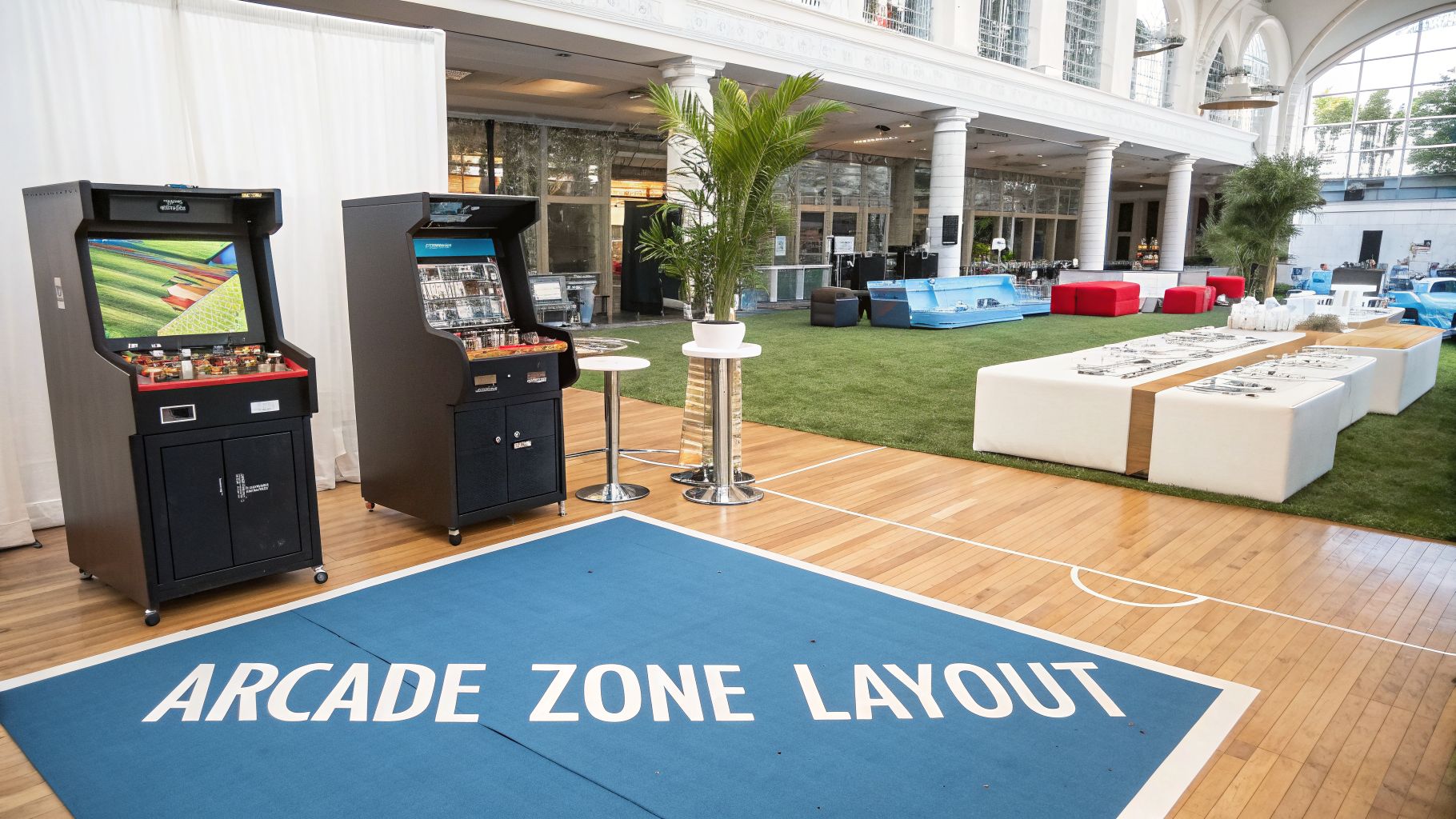 Two retro arcade machines showcased in a modern event setup with an 'Arcade Zone Layout' mat.