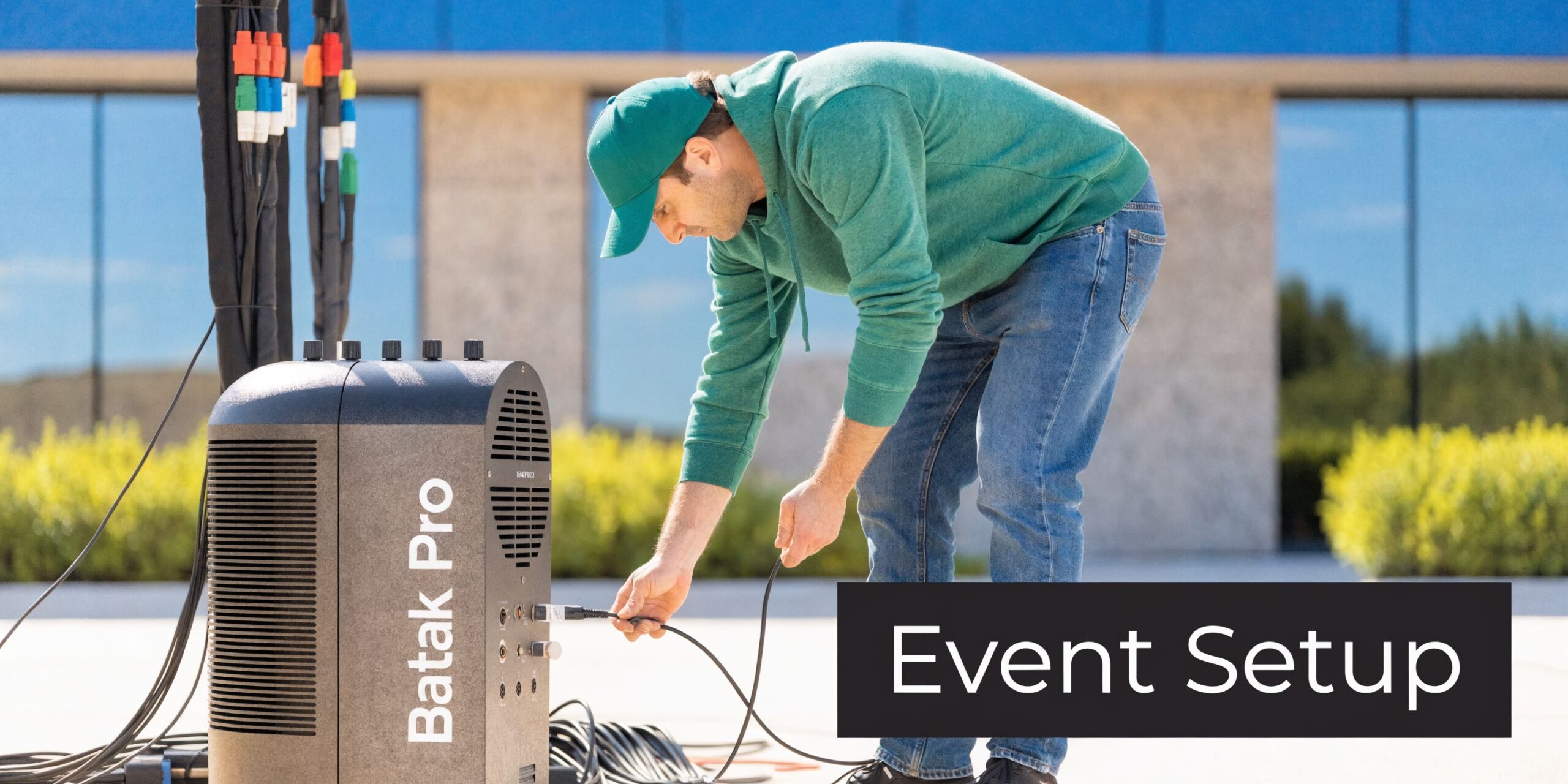A technician sets up a Batak Pro reaction training machine at an outdoor event venue.
