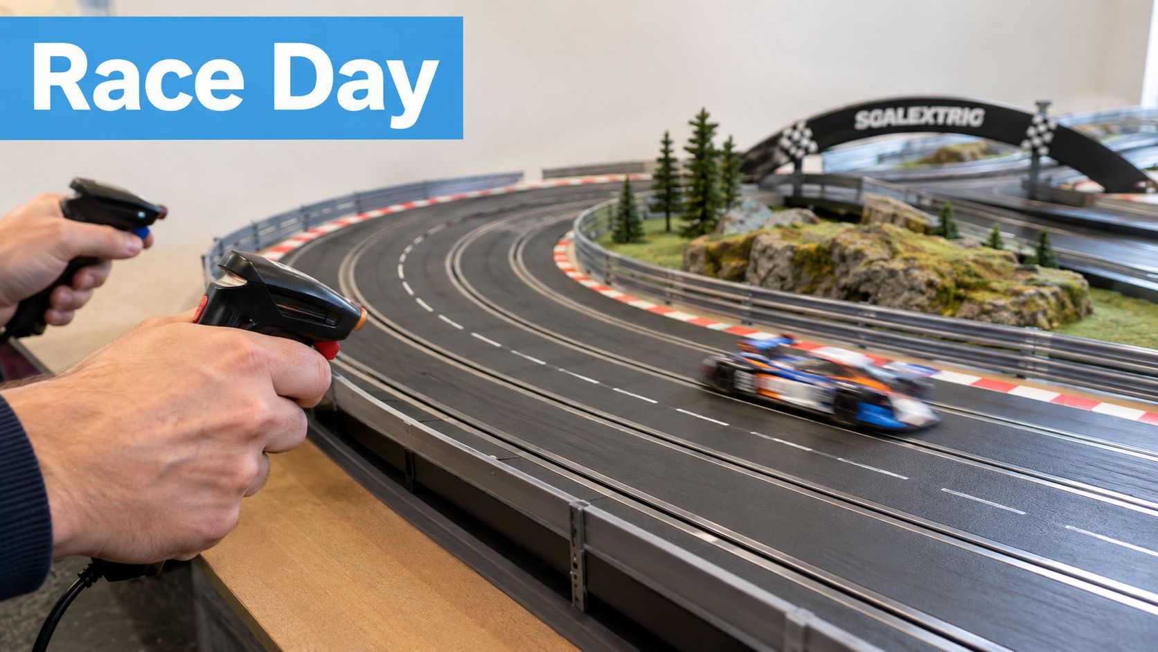 A person holding a remote controller while racing a small slot car on a Scalextric track.